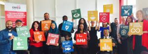 CEMVO Equalities Event attendees posing with SDG cards